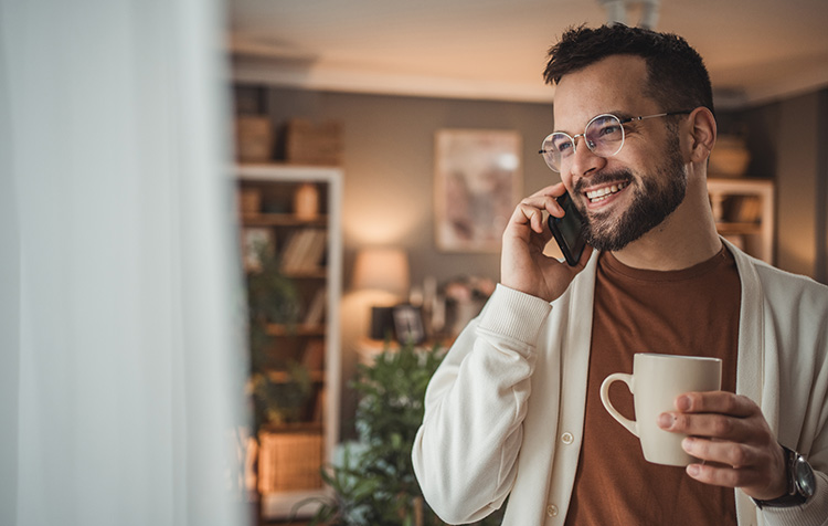 A man on the phone in a living room.